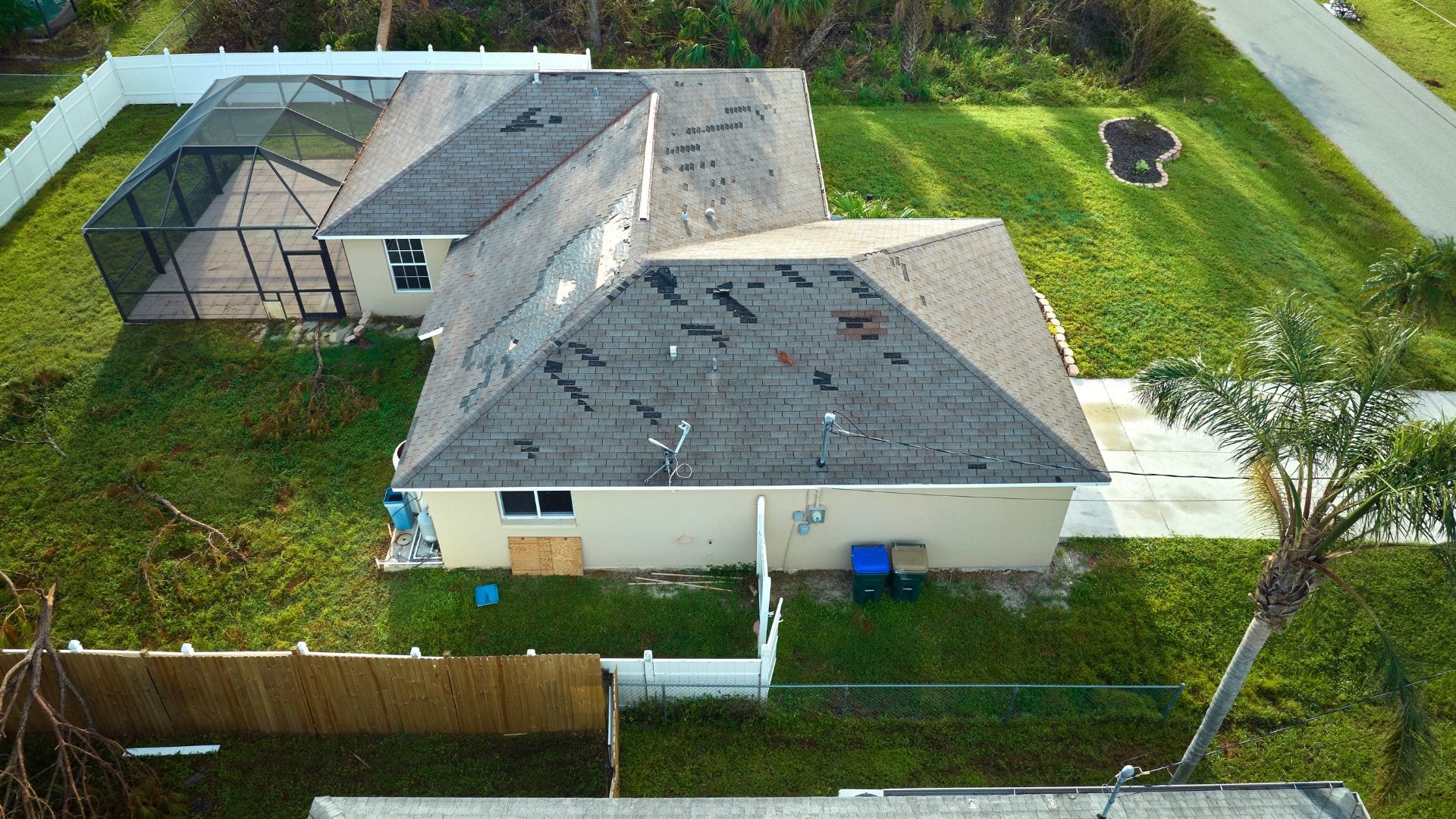 Aerial view of a storm-damaged shingle roof in coastal South Carolina