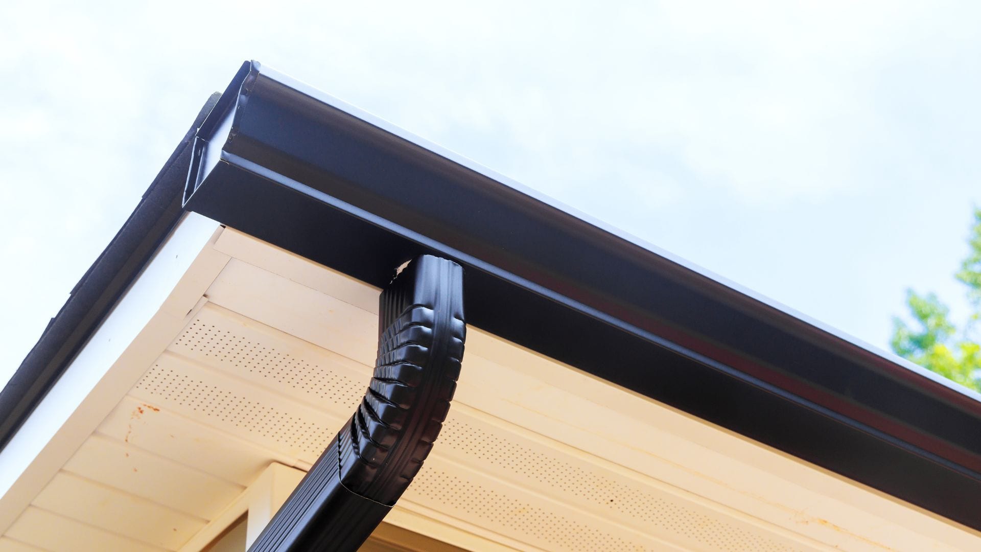 Downspout elbow and gutter corner on a residential soffit