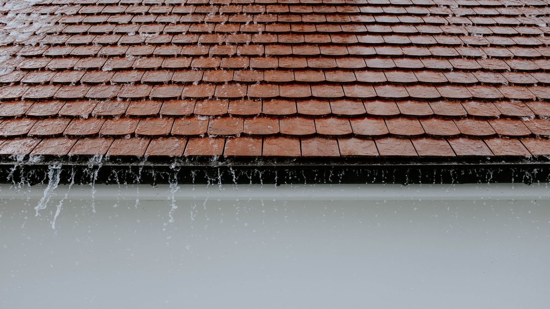 Rainwater sheeting off a roof edge in a Carolina storm
