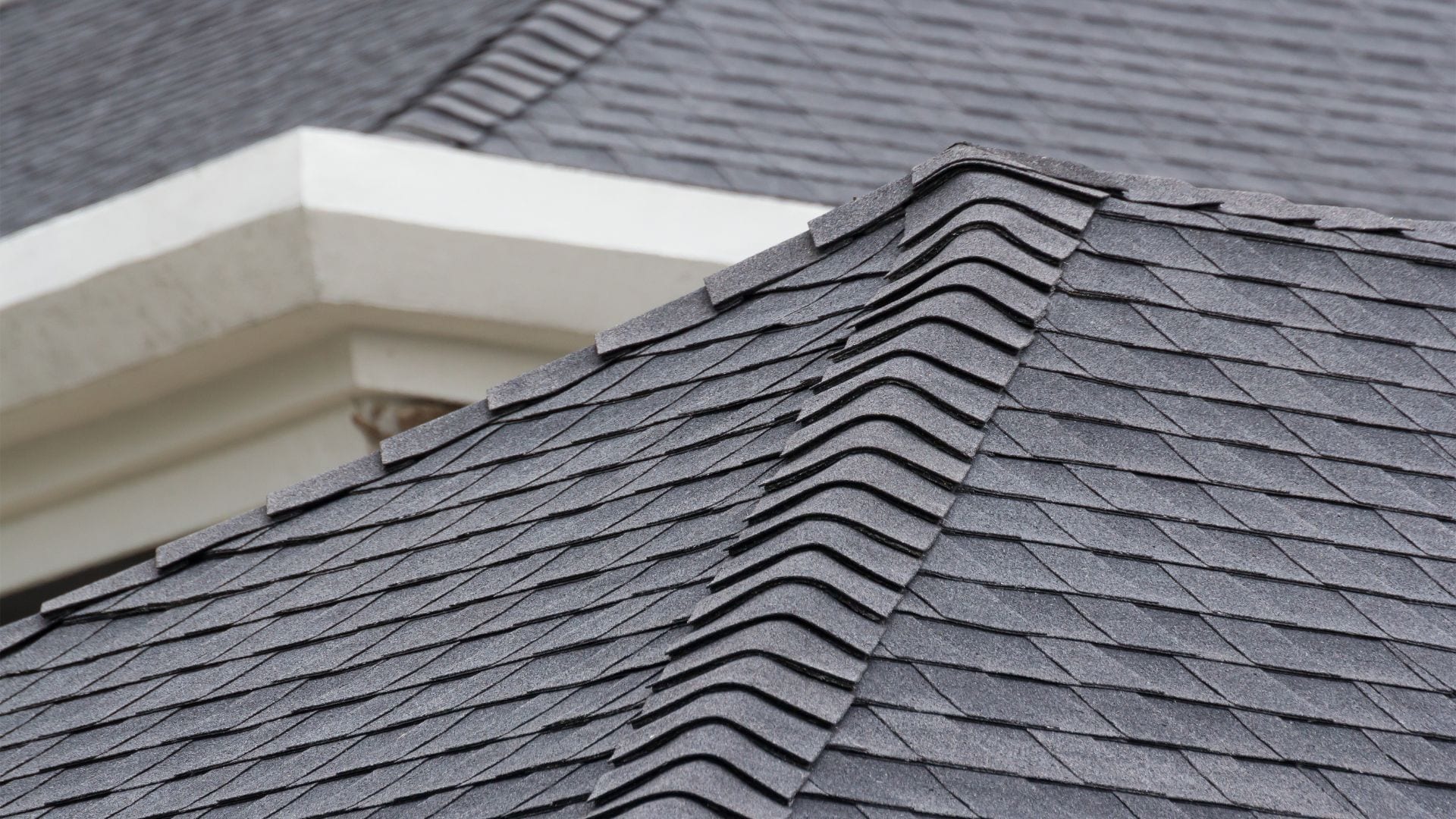 Ridge cap shingles running along a roof peak