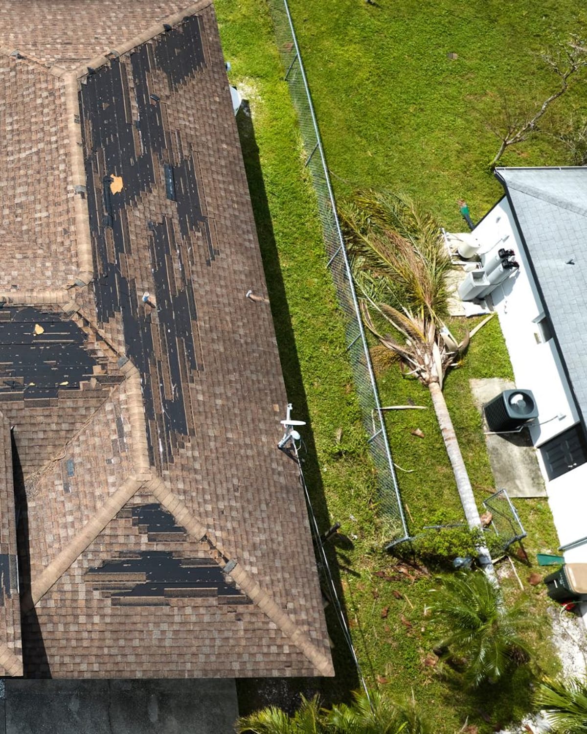 Top-down drone image of a residential roof showing wear across multiple slopes
