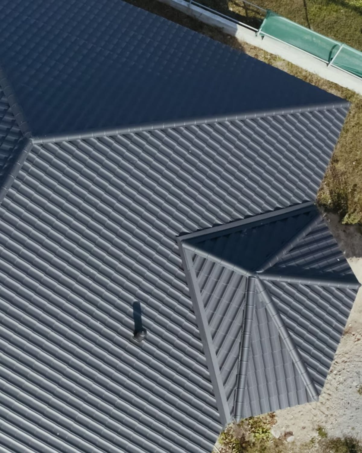 Overhead view of a skylight set into a roof plane with surrounding penetrations