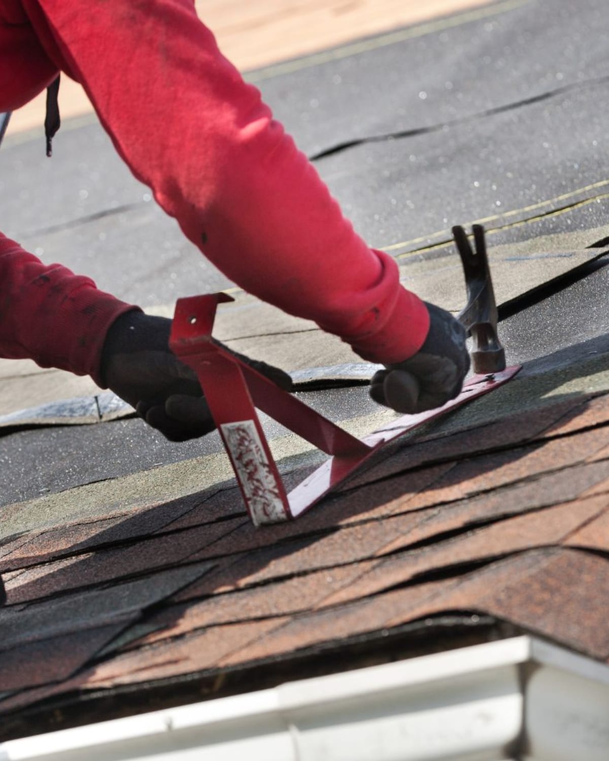 Golden Roofing installer setting roof jacks on a shingle roof in Myrtle Beach, SC