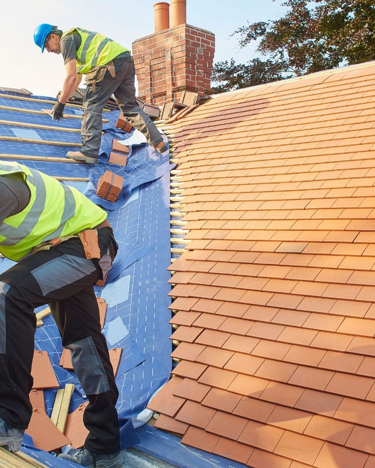 Golden Roofing installers working a roof section on the Grand Strand