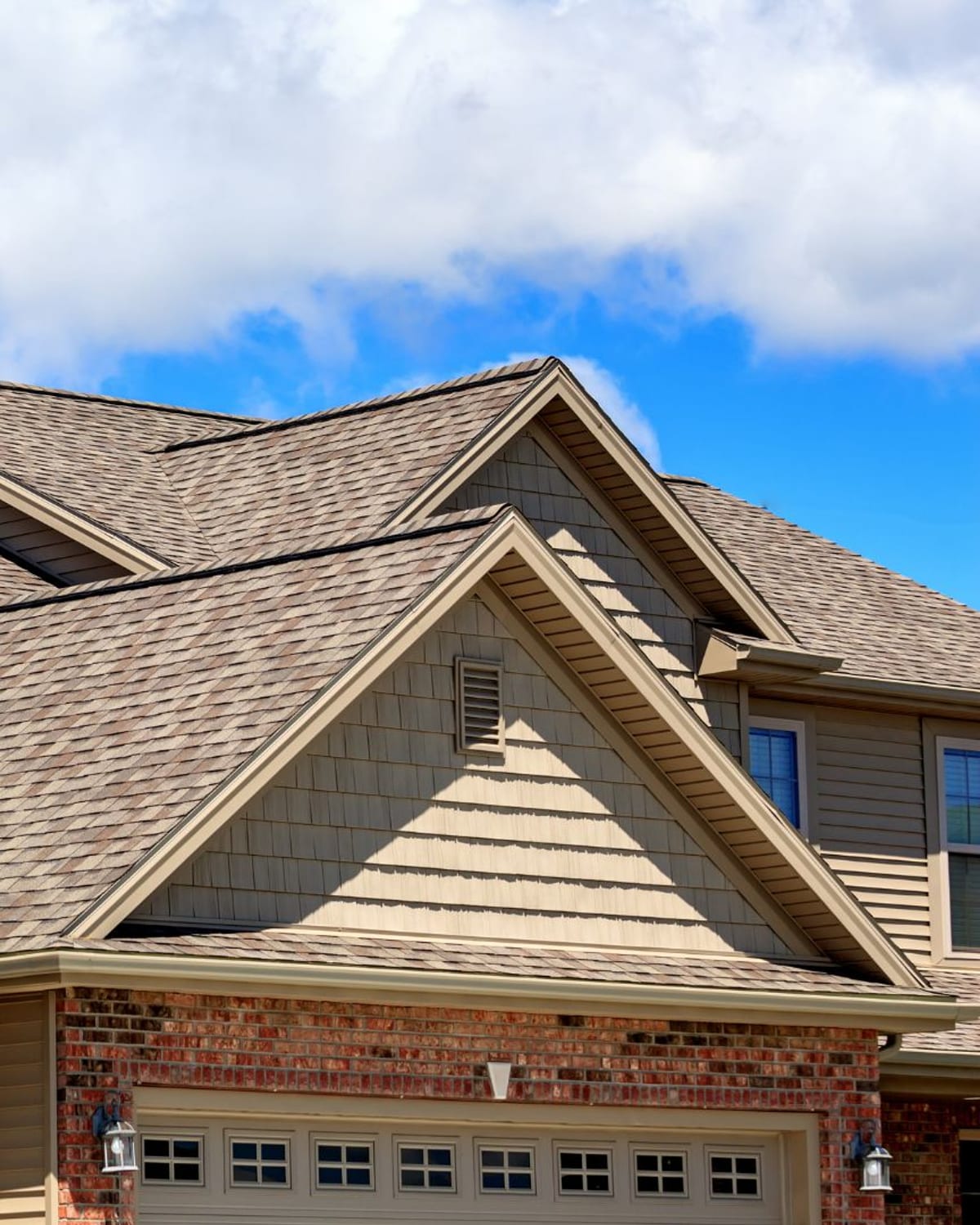 Two-story Myrtle Beach, SC home with a new tan architectural shingle roof