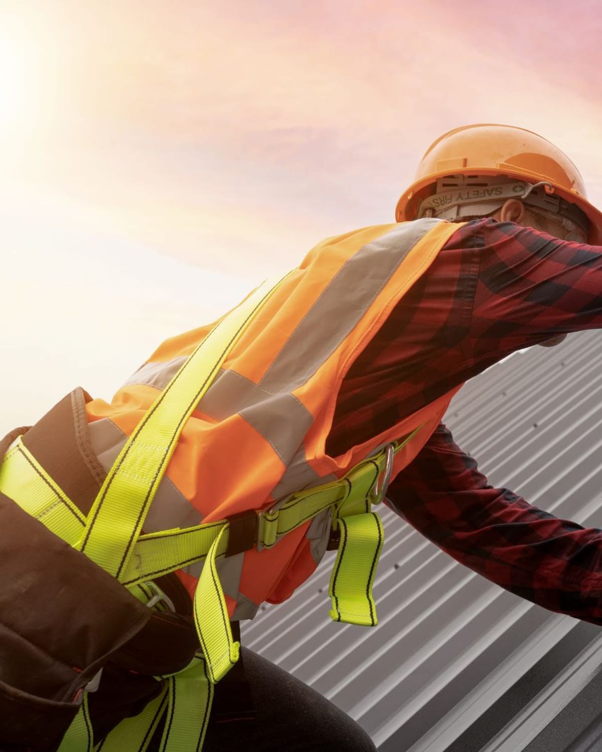 Installer driving fasteners into a metal roof panel on a property near Aynor, SC