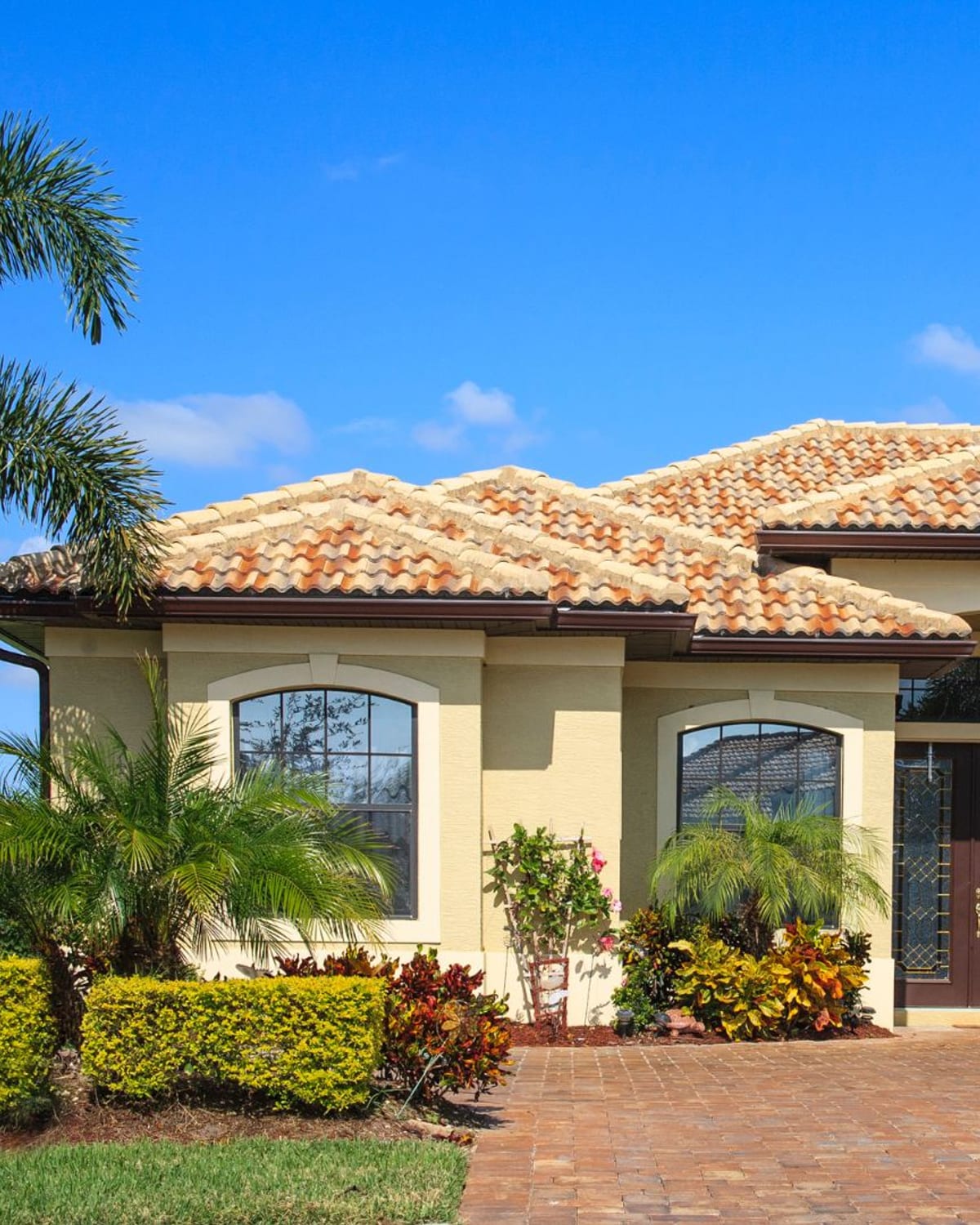 Pawleys Island area home with a tile roof and paver driveway
